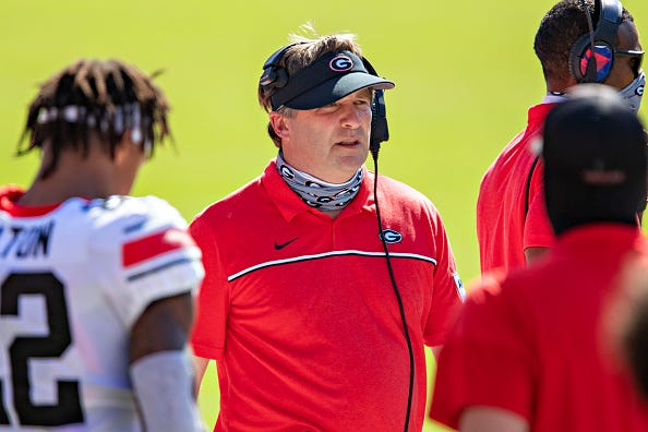 Kirby Smart talks with his players at UGA.