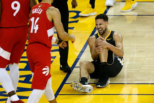 Klay Thompson grabs his knee in pain during Game 6 of the 2019 NBA Finals.