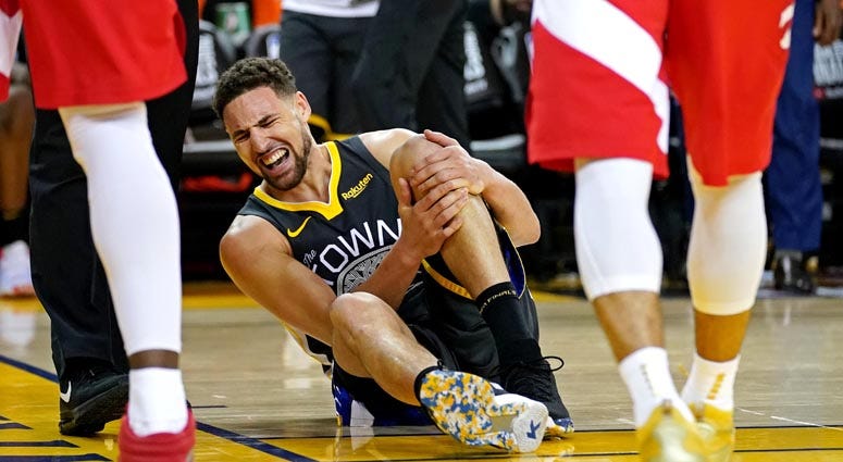 Golden State Warriors guard Klay Thompson reacts after an injury against the Toronto Raptors in gGame 6 of the NBA Finals on June 13, 2019, at Oracle Arena in Oakland, California.