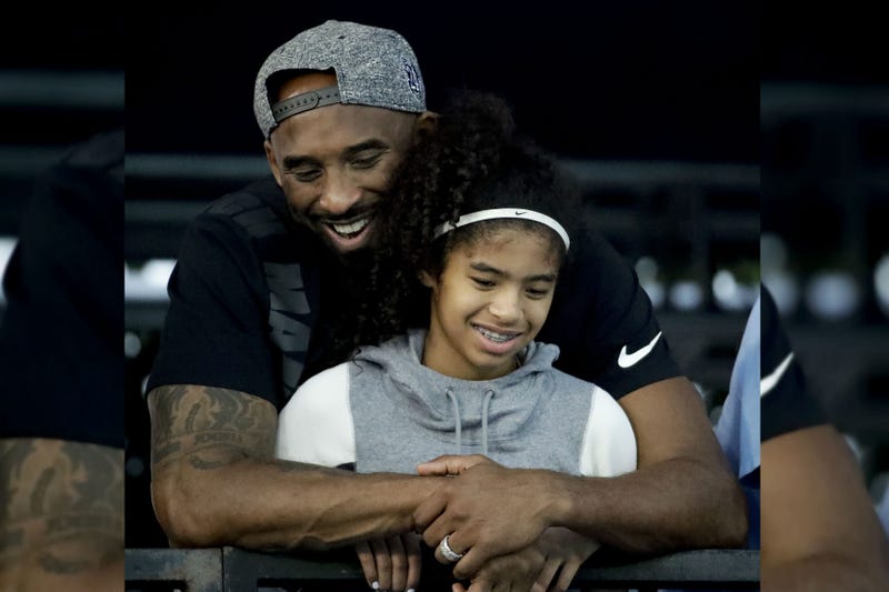 Former Los Angeles Laker Kobe Bryant and his daughter Gianna watch during the U.S. national championships swimming meet in Irvine, Calif., in 2018.