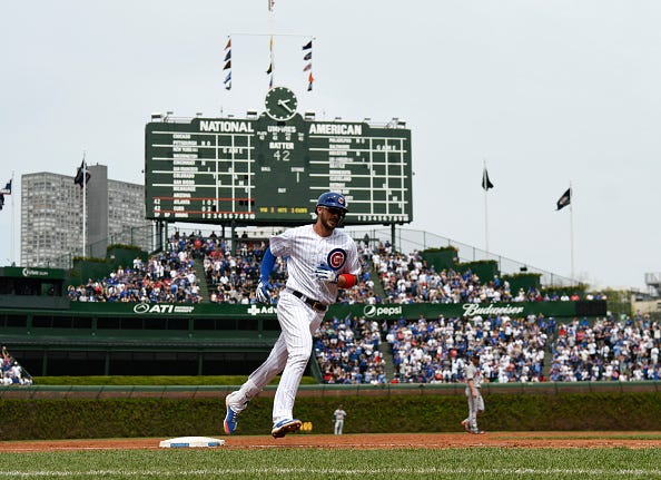 Kris Bryant rounds the bases after blasting a home run at Wrigley Field.