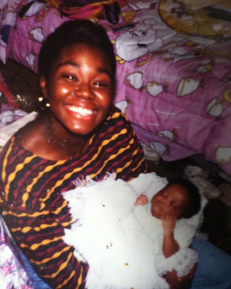 Cynthia Kudji at 22, posing with daughter Jasmine a few days after her birth