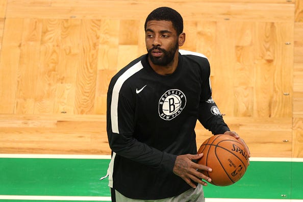 Kyrie Irving warms up before a Nets game.