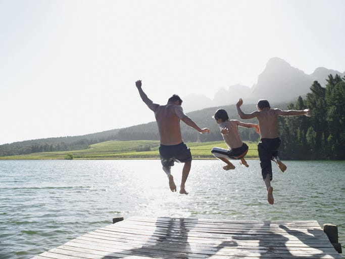 Dad & 2 boys jumping off dock into lake