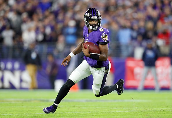 Ravens QB Lamar Jackson looks for room in the open field to make a move.
