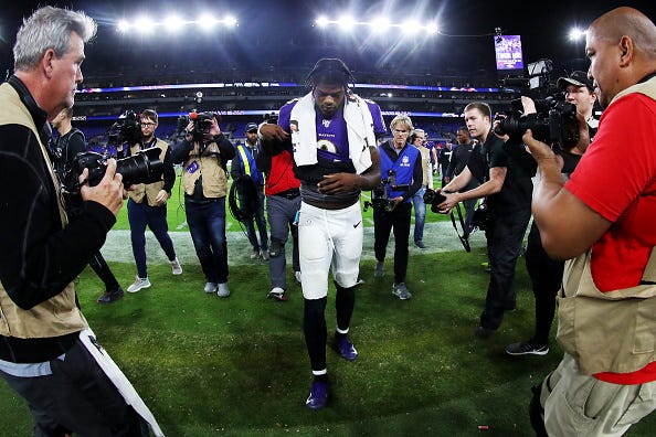 Lamar Jackson walks off the field after a Ravens playoff loss.