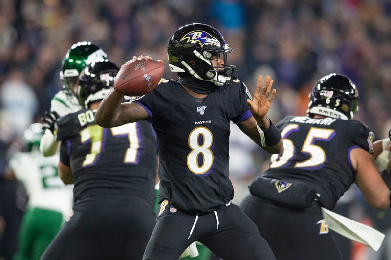 Lamar Jackson throws a TD pass in the third quarter in a 42-21 win over the Jets.
