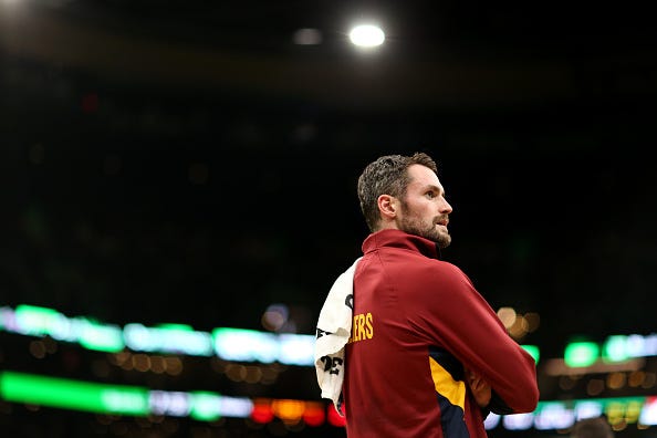 Kevin Love looks on from the bench before a game vs. the Celtics.