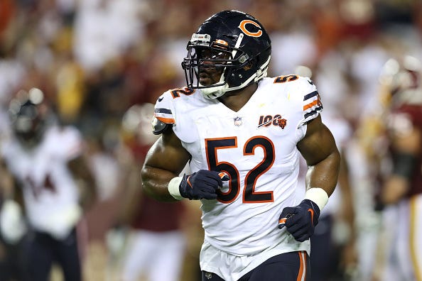 Khalil mack jogs onto the field for the Bears.