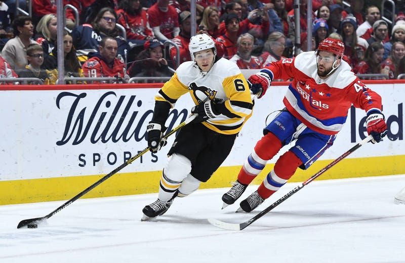 Pittsburgh Penguins defenseman John Marino (6) carries the puck as Washington Capitals right wing Tom Wilson (43) chases during the first period at Capital One Arena.