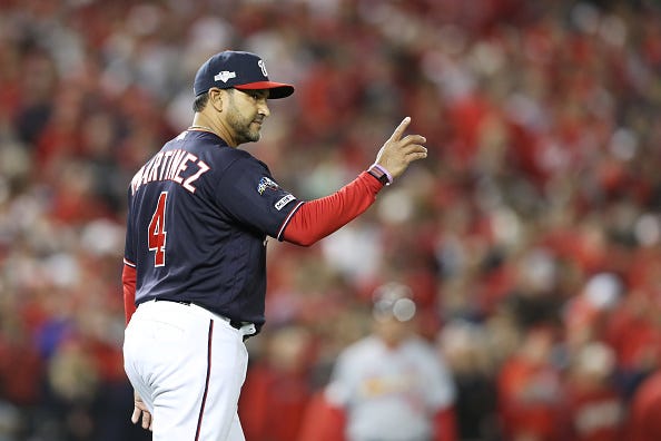 Nationals manager Dave Martinez signals for a pitching change.