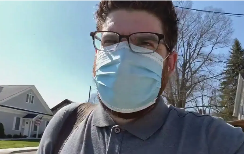 man in a facemask walking outside