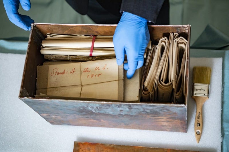 Tim Frank, historian, History Office; reaches into the newly opened Memorial Amphitheater memorabilia box