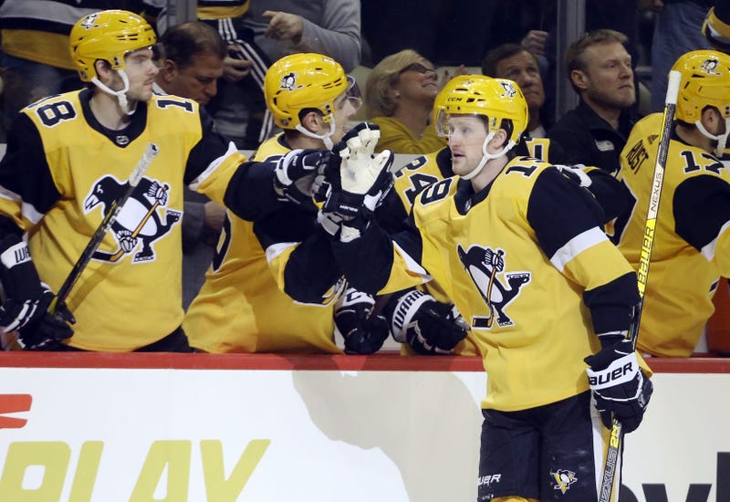 Pittsburgh Penguins center Jared McCann (19) celebrates his goal with the Pens bench against the Florida Panthers during the first period at PPG PAINTS Arena.