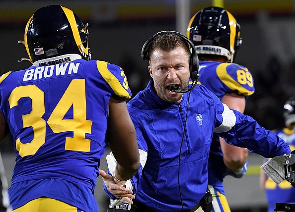 Sean McVay high-fives running back Malcolm Brown