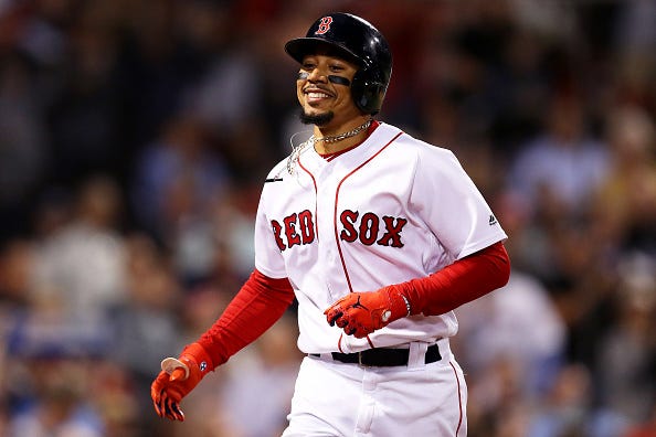 Mookie Betts is all smiles as he crosses the plate.