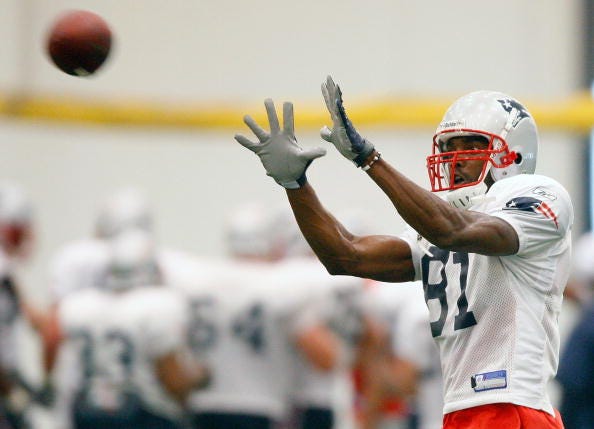 Randy Moss catches a ball in training camp for the Patriots.