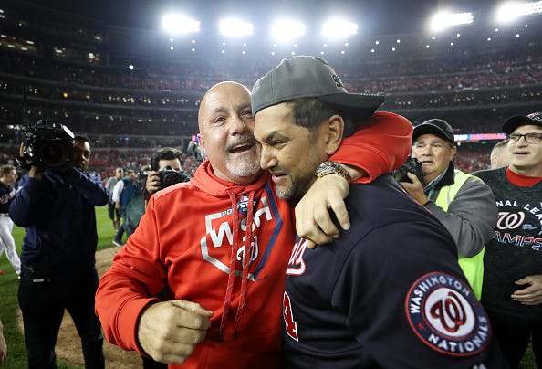 Nationals GM Mike Rizzo (l.) celebrates with manager Dave Martinez