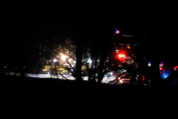 Mendon firefighters and other emergency personnel respond to a military helicopter crash in a field near Cheese Factory Road and W. Bloomfield Road in Mendon, N.Y., late Wednesday, Jan. 20, 2021. Three National Guard members on the routine training flight were killed, according to authorities. (Tina MacIntyre-Yee/Democrat & Chronicle via AP)