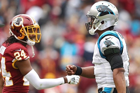 Josh Norman daps up Cam Newton before a game vs. the Panthers.