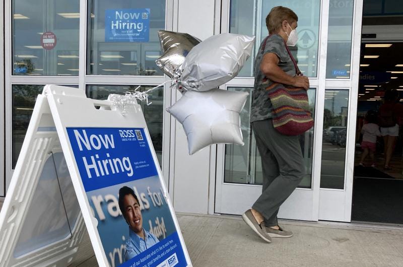 A shopper passes a hiring sign while entering a retail store in Morton Grove, Ill., Wednesday, July 21, 2021. Despite an uptick in COVID-19 cases and a shortage of available workers, the U.S. economy likely enjoyed a burst of job growth last month as it bounces back with surprising vigor from last year’s coronavirus shutdown. The Labor Department’s July jobs report Friday, Aug. 6 is expected to show that the United States added more than 860,000 jobs in July, topping June’s 850,000, according to a survey of economists by the data firm FactSet.