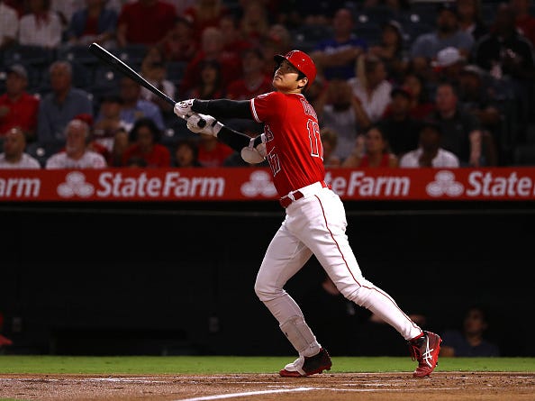 Shohei Ohtani watches as he skies a ball toward the outfield.