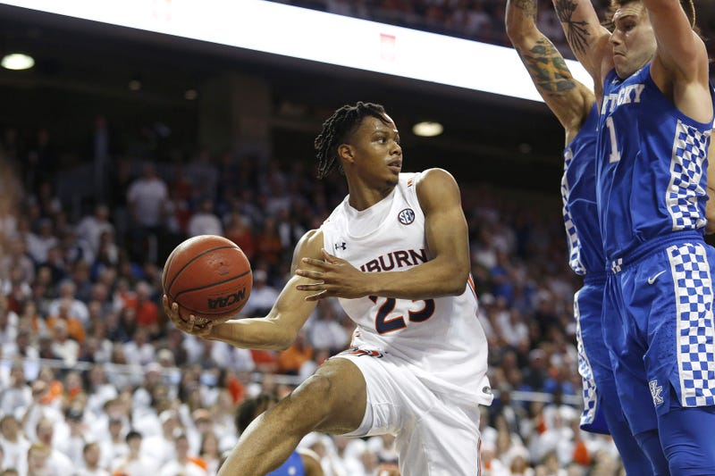 Auburn Tigers forward Isaac Okoro passes the ball as Kentucky Wildcats forward Nate Sestina applies pressure during a game last season.