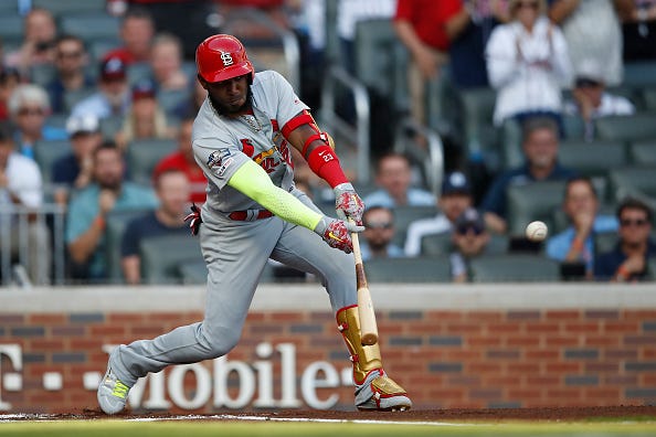 Marcell Ozuna swings at a pitch against the Braves in the NLDS.