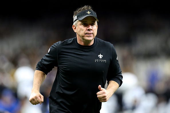 Sean Payton jogs off the field before a Saints game.