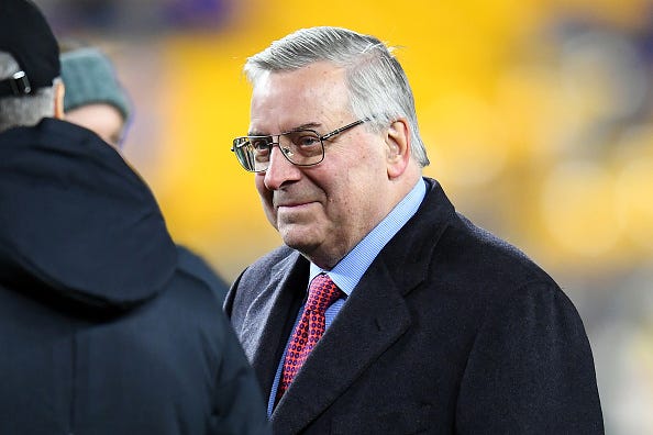 Bills owner Terry Pegula on the field before a game.