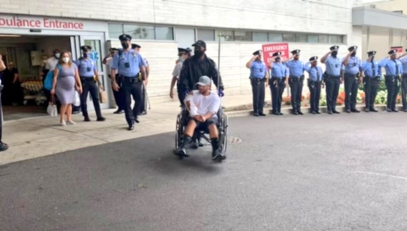 Philadelphia police officer Arcenio Perez, being taken in a wheelchair from Penn Presbyterian Medical Center after his recovery from being shot during an exchange of gunfire on October 4.