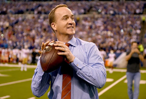 A retired Peyton Manning still tosses the football before a game.