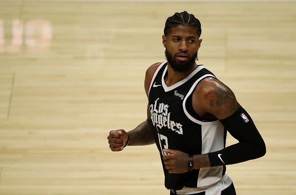 Paul George runs down the court during a Clippers game .