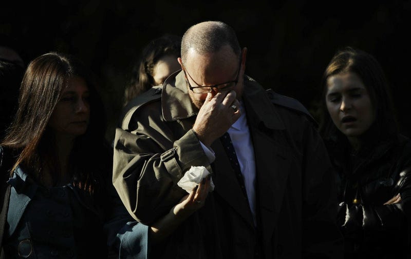 A mourner reacts outside Rodef Shalom Congregation before the funeral services for brothers Cecil and David Rosenthal, Tuesday, Oct. 30, 2018, in Pittsburgh.