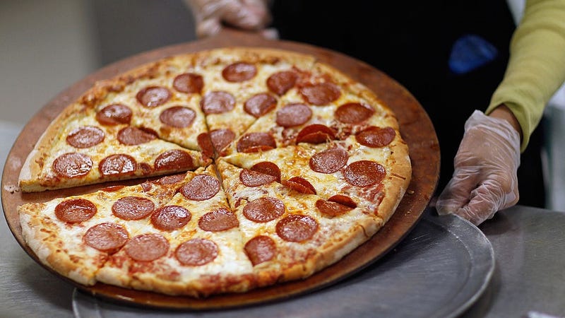 Terry Cheung prepares a pizza pie to be served to students at Everglades High School on November 18, 2011 in Miramar, Florida.