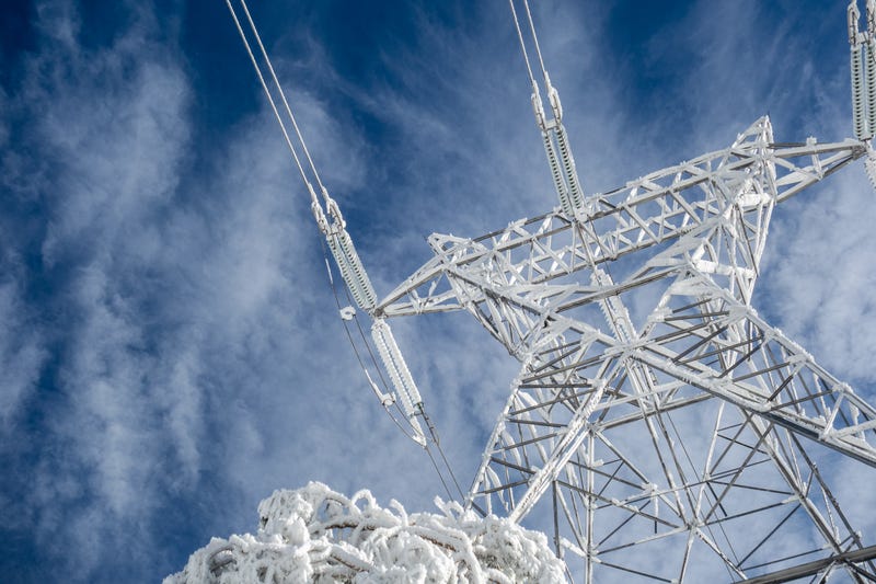 High voltage electric tower on a snowy day