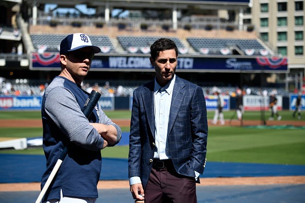Padres GM A.J. Preller (r.) talks with former manager Andy Green.