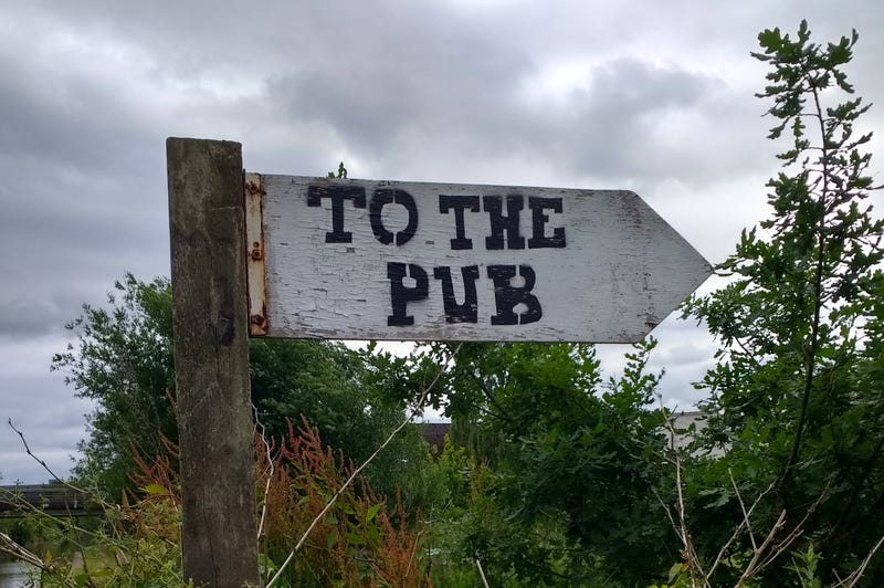A sign pointing the way to the pub
