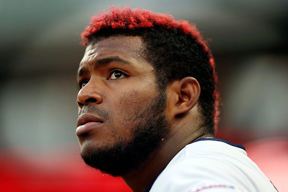 Outfielder Yasiel Puig looks on from the Indians' dugout