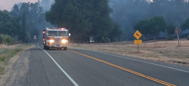 A fire rig speeds down a road as crews battle the Quail Fire in Solano County.