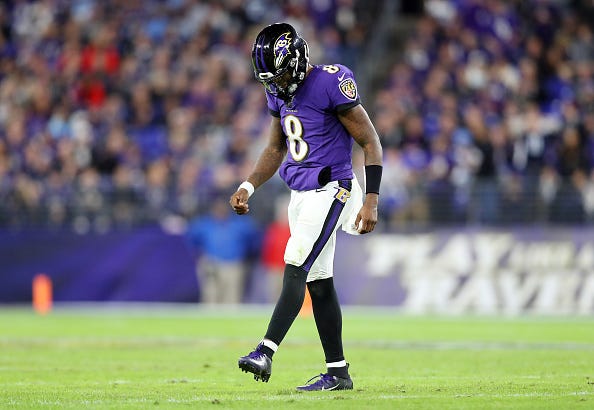 Ravens QB Lamar Jackson hangs his head after a frustrating night.