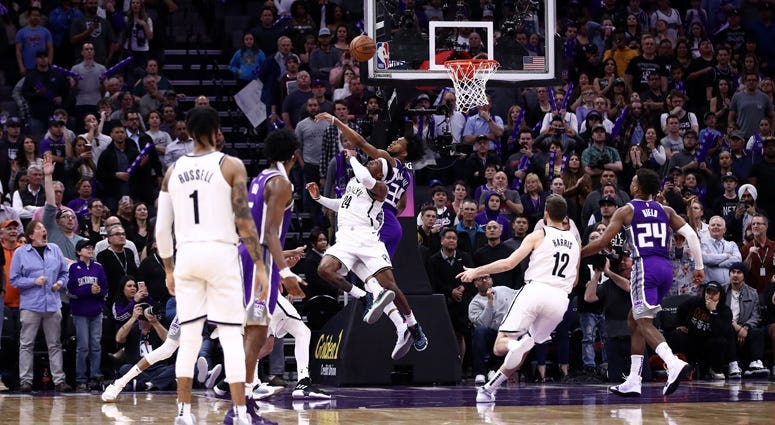 Rondae Hollis-Jefferson of the Brooklyn Nets makes the game-winning shot while guarded by Marvin Bagley III of the Sacramento Kings with two seconds left in the game at Golden 1 Center on March 19, 2019 in Sacramento, California.