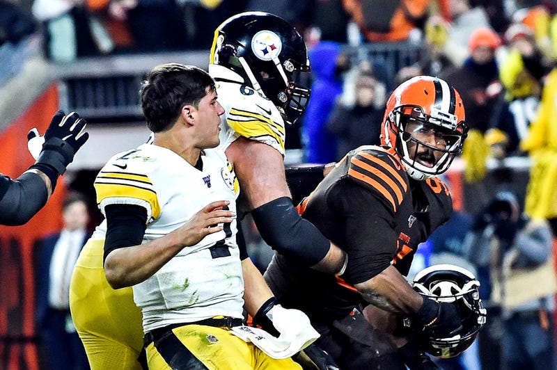 Nov 14, 2019; Cleveland, OH, USA; Cleveland Browns defensive end Myles Garrett (95) hits Pittsburgh Steelers quarterback Mason Rudolph (2) with his own helmet as offensive guard David DeCastro (66) tries to stop Garrett during the fourth quarter at FirstE