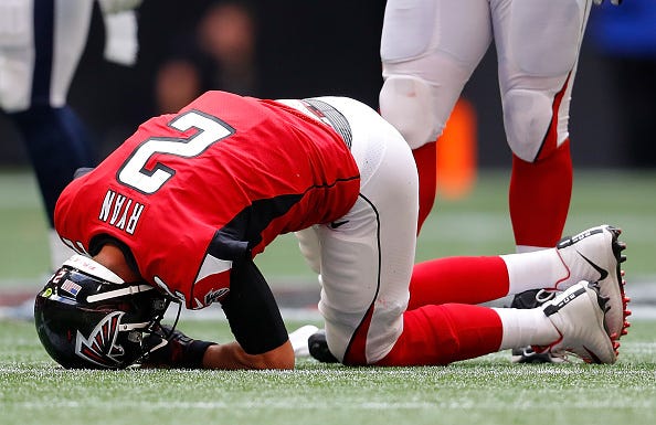 Matt Ryan drops in pain during a game against the Rams.