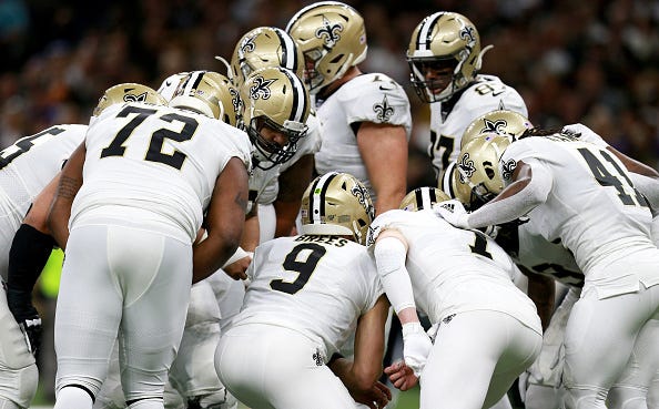 Drew Brees calls out the play inside a Saints huddle.