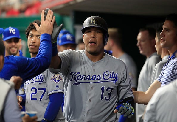 Salvador Perez celebrates a home run in the Royals dugout.
