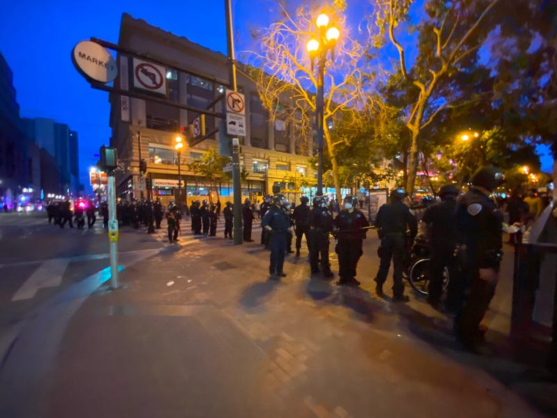 Police stand on Market St. In San Francisco as looters hit stores along the strip.