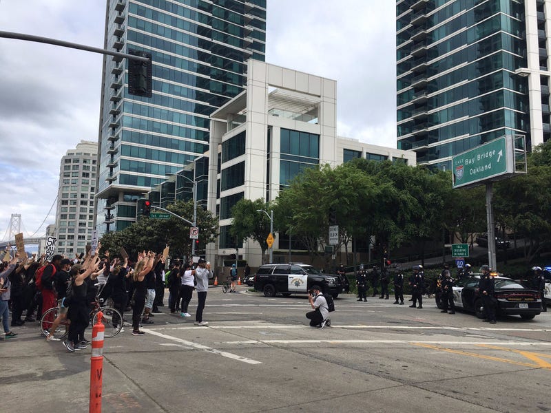 Protesters are stopped from entering a Bay Bridge on-ramp by CHP officers at a San Francisco rally.