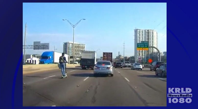 Man Riding Electric Scooter On Interstate