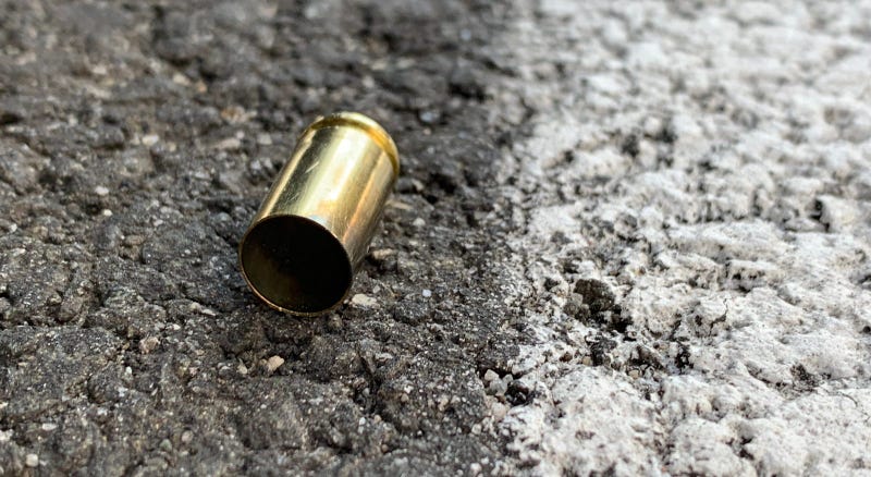 An empty shell casing on the ground